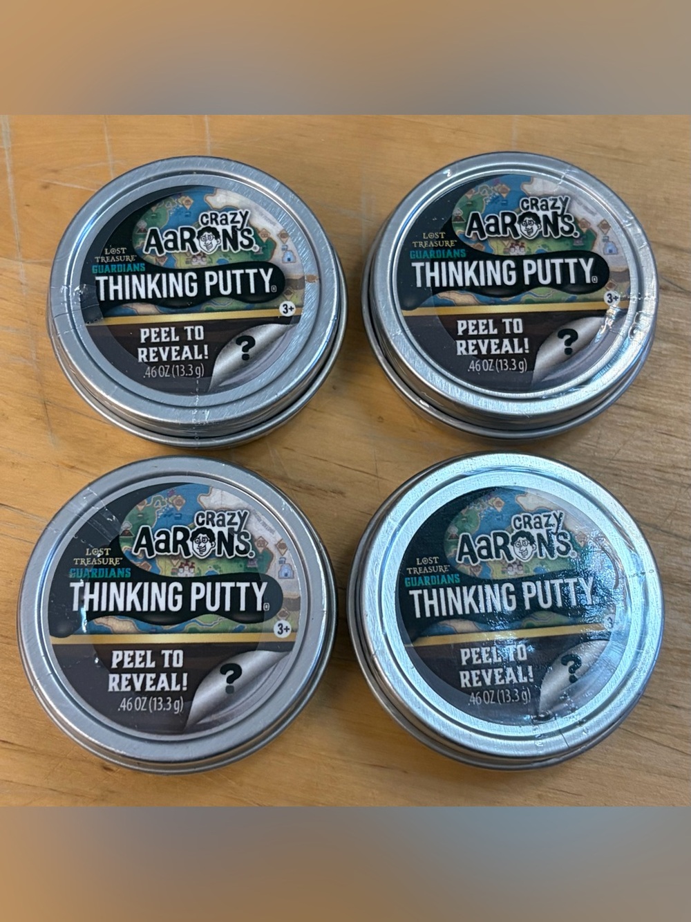 (4) Crazy Aaron’s Thinking Putty Mini Tins “Peel To Reveal”